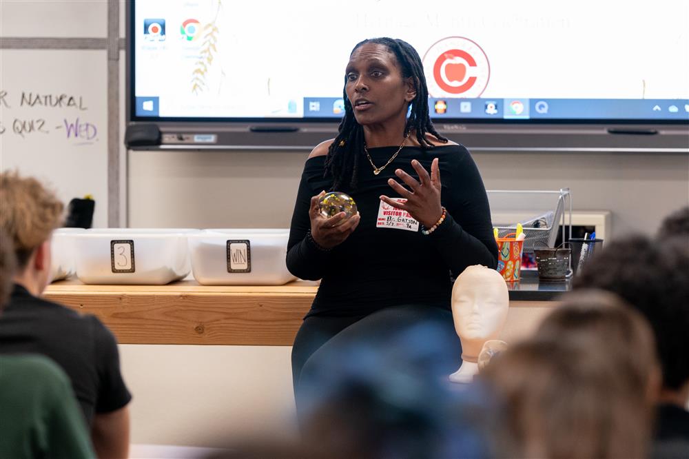 A guest speaker talks with a class.